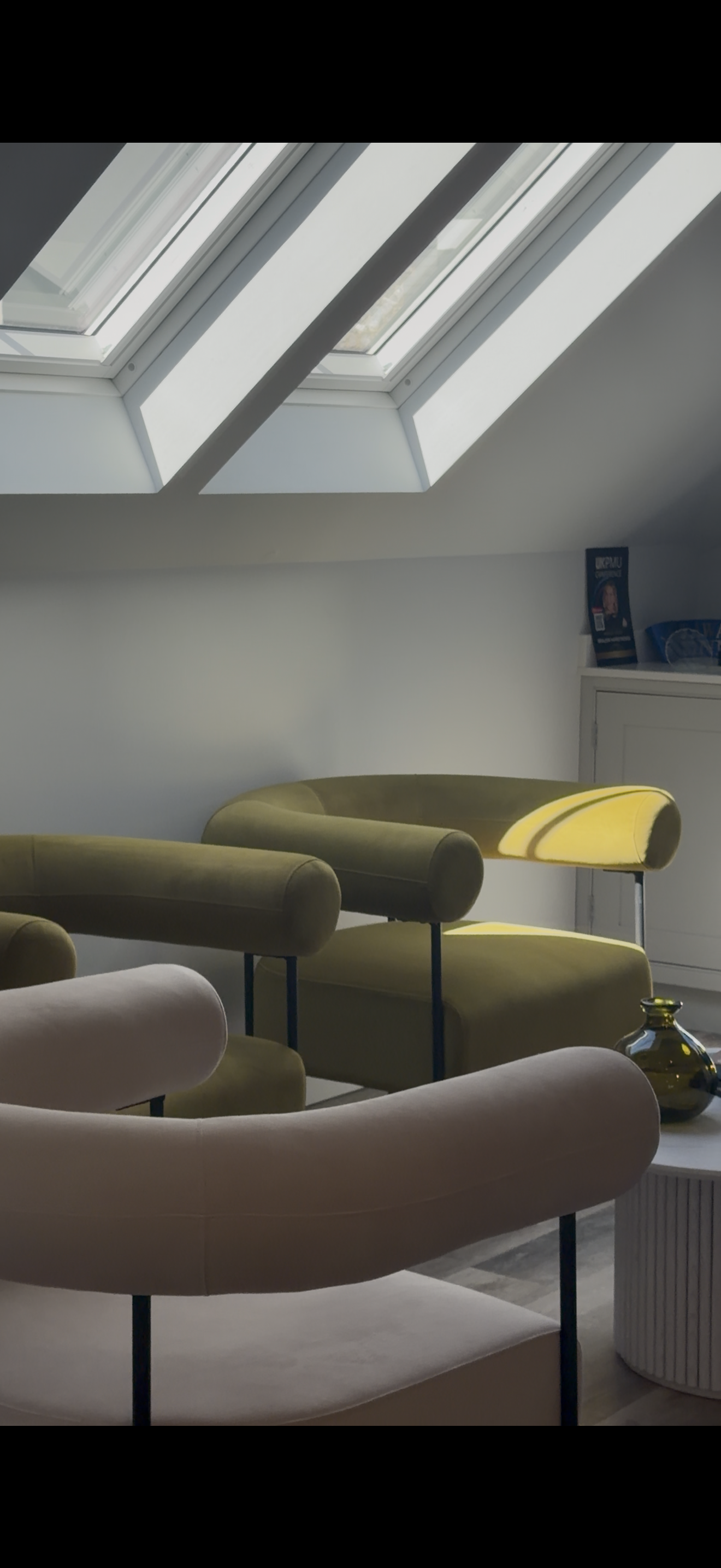 The Aesthetic Space studio lounge with skylights and contemporary chairs